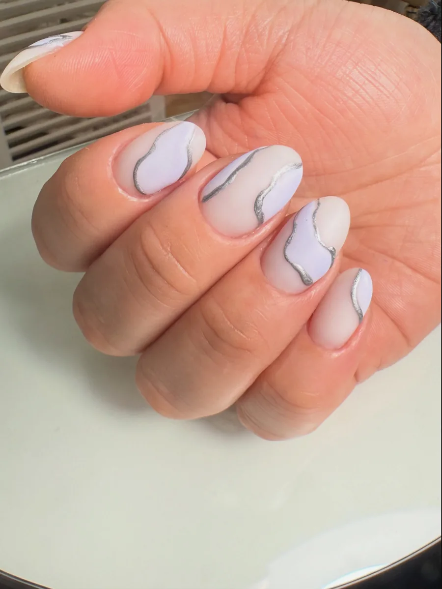 Uñas blancas con ondas plateadas realizadas por María Suárez